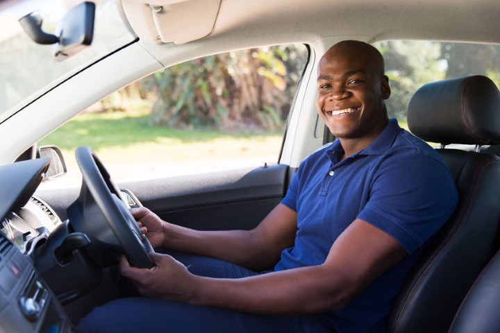 32518004 - cheerful african man inside his new car